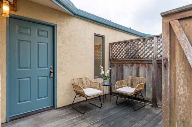 view of exterior entry with a wooden deck