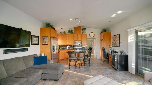 living room featuring beverage cooler and vaulted ceiling