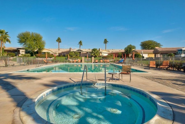 view of pool with a patio area and a hot tub