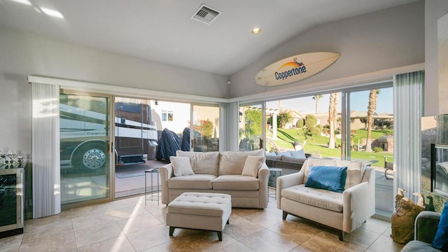 sunroom / solarium featuring lofted ceiling and wine cooler