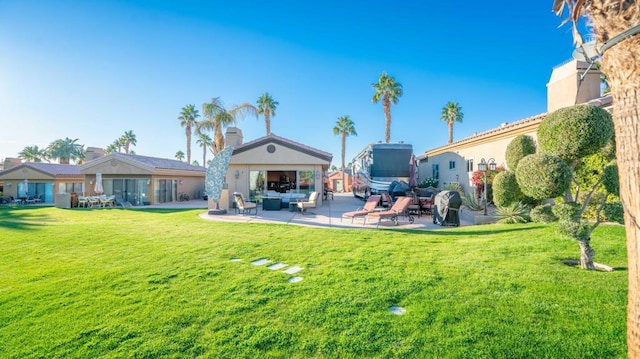 rear view of property featuring a patio and a yard