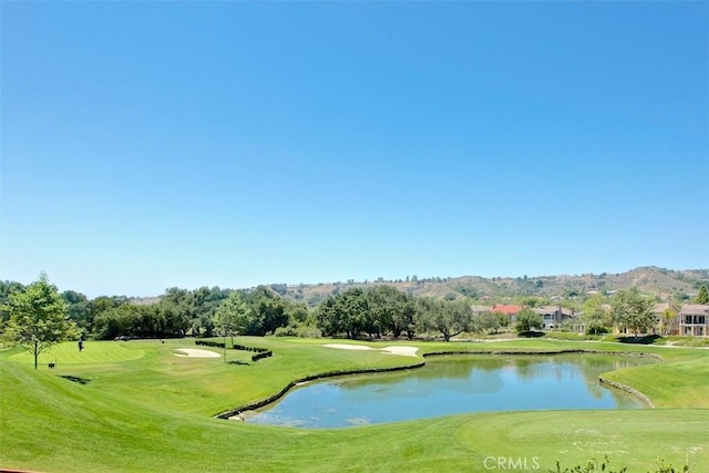 view of property's community featuring a water view and a yard