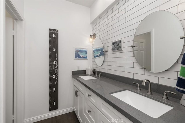 bathroom with wood-type flooring, tasteful backsplash, and vanity