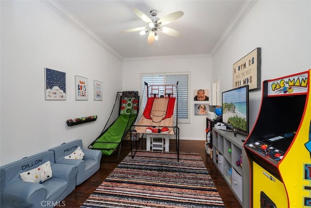 rec room featuring ceiling fan, dark hardwood / wood-style flooring, and crown molding