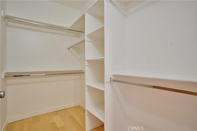 spacious closet featuring hardwood / wood-style floors