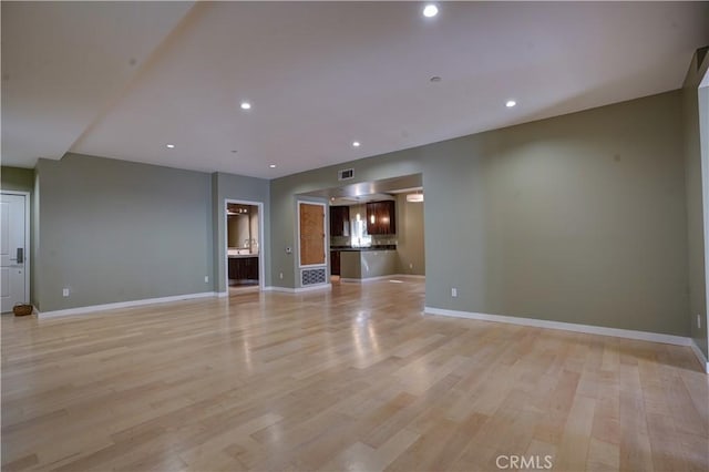 unfurnished living room featuring light hardwood / wood-style floors