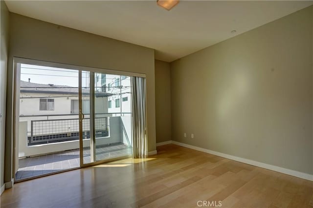 spare room with light hardwood / wood-style flooring