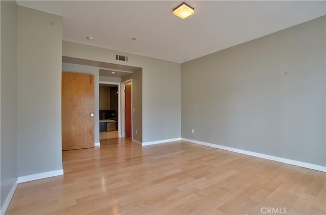 spare room with light hardwood / wood-style floors