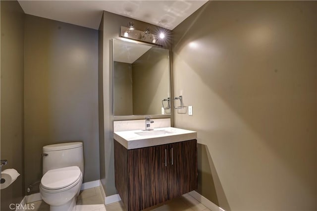 bathroom featuring toilet, vanity, and tile patterned floors