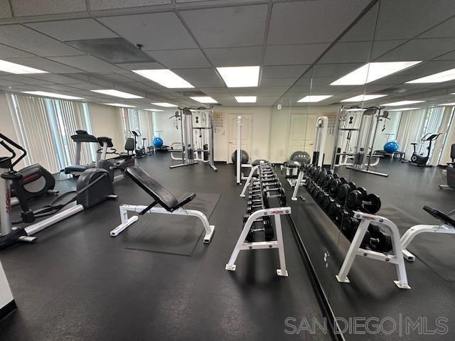 workout area with a paneled ceiling