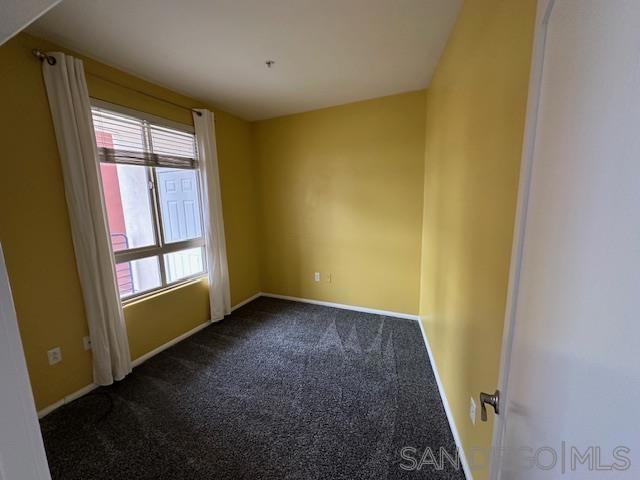 carpeted spare room featuring plenty of natural light