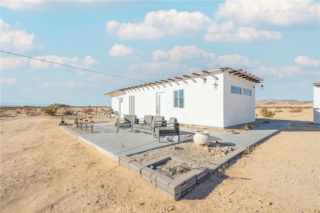 rear view of property featuring a patio area