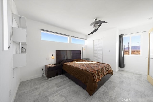 bedroom with ceiling fan and a closet