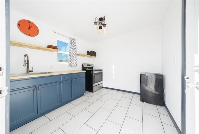 kitchen with blue cabinetry, electric range, and sink