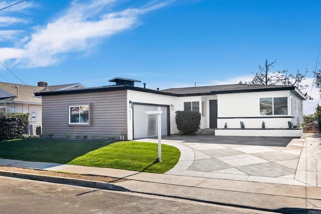 single story home featuring a front lawn and a garage