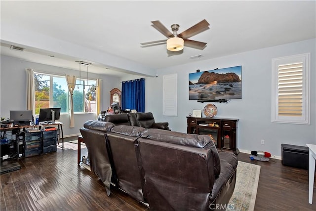 living room with ceiling fan and dark wood-type flooring