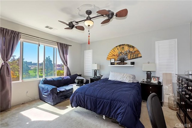 bedroom featuring ceiling fan and light carpet