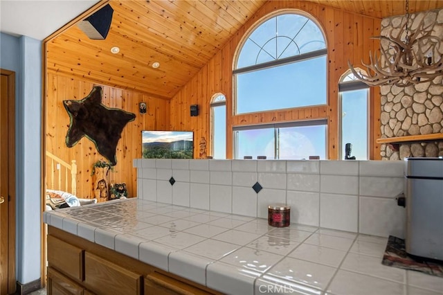 2477 Spring Oak Dr, Running Springs, CA 92382 - kitchen with wood ceiling, tile countertops, wooden walls, and high vaulted ceiling