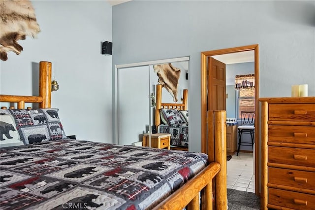 bedroom featuring tile patterned flooring and a closet