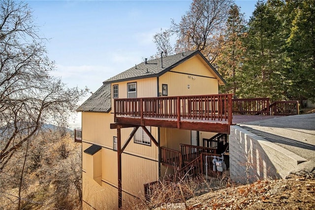 2477 Spring Oak Dr, Running Springs, CA 92382 - back of property with a shingled roof and a wooden deck