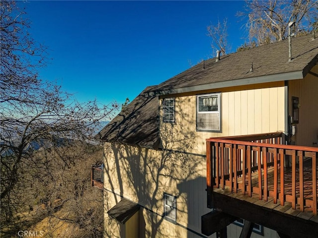 2477 Spring Oak Dr, Running Springs, CA 92382 - view of side of property with a wooden deck and roof with shingles