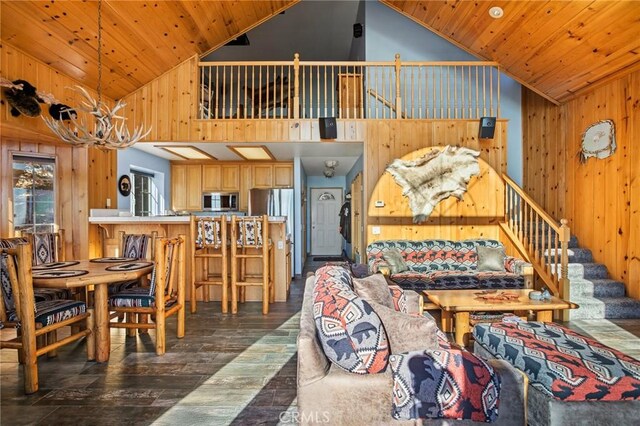 interior space featuring high vaulted ceiling, dark hardwood / wood-style floors, wood ceiling, and wood walls