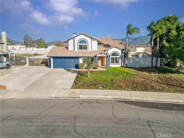 view of property with a front lawn, a garage, and a mountain view