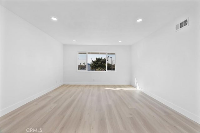 spare room featuring light hardwood / wood-style floors