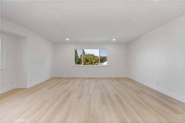 empty room with light hardwood / wood-style floors