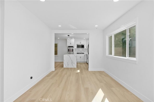 unfurnished living room with light hardwood / wood-style flooring