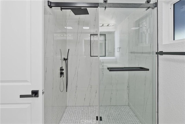 bathroom with a shower with shower door