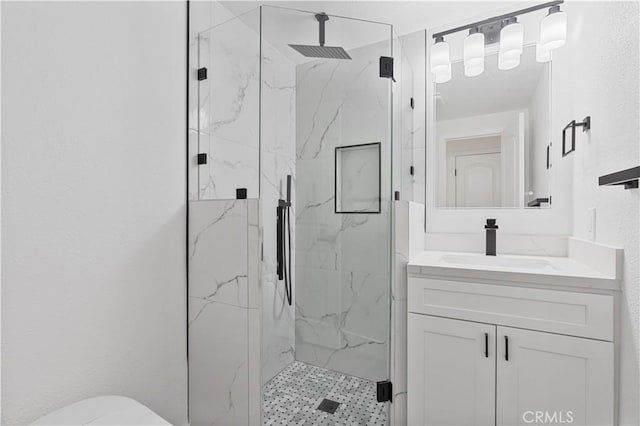 bathroom with toilet, a shower with door, and vanity