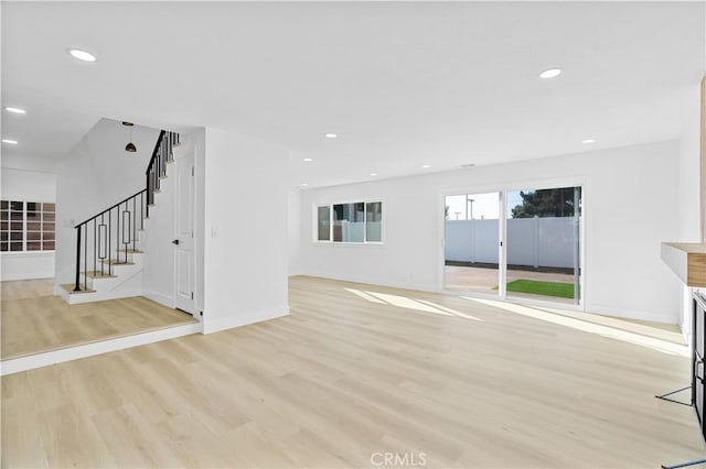 unfurnished living room featuring light wood-type flooring