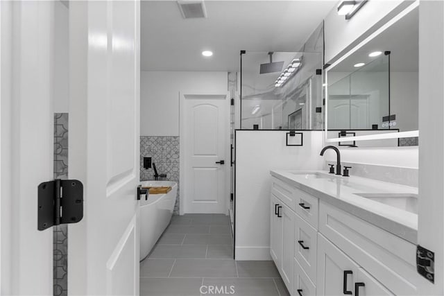 bathroom featuring shower with separate bathtub, vanity, and tile patterned flooring