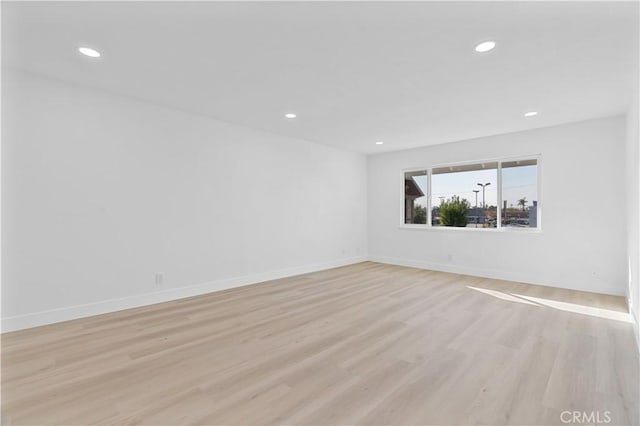 unfurnished room with light hardwood / wood-style flooring