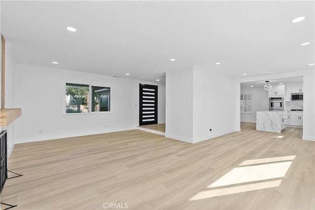 unfurnished living room with light hardwood / wood-style floors