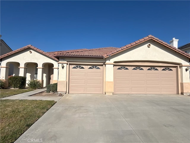 mediterranean / spanish-style house featuring a garage