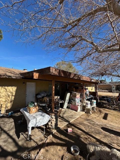 view of side of home with a patio area