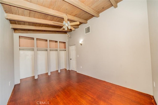 unfurnished bedroom featuring beam ceiling, hardwood / wood-style flooring, and wooden ceiling