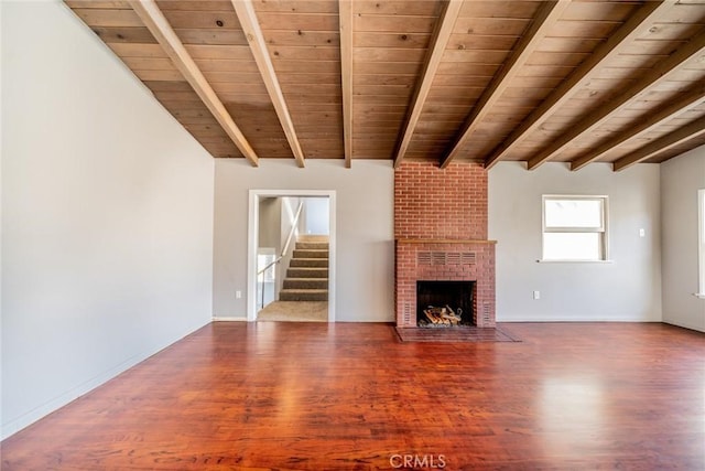 unfurnished living room featuring a brick fireplace, wooden ceiling, hardwood / wood-style floors, and beam ceiling