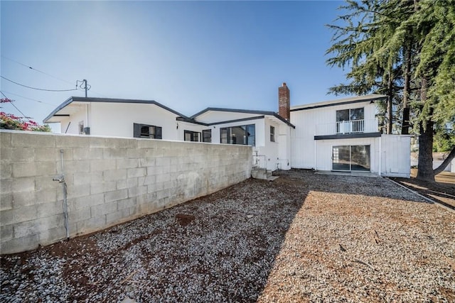 rear view of house featuring a balcony