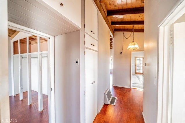 hall featuring vaulted ceiling with beams, wood-type flooring, an inviting chandelier, and wooden ceiling