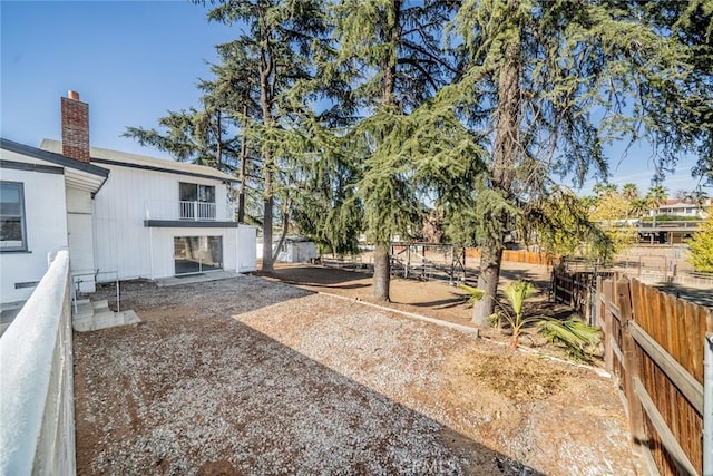 view of yard with a balcony