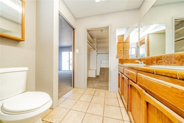 bathroom featuring toilet, vanity, and tile patterned flooring