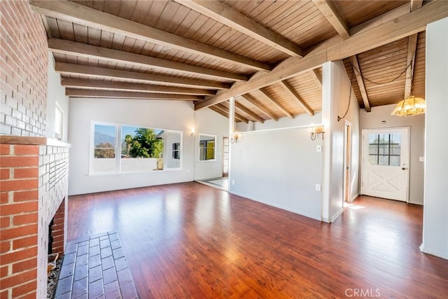 unfurnished living room featuring a fireplace, a healthy amount of sunlight, lofted ceiling with beams, and wood ceiling