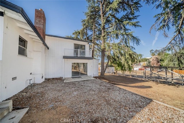 rear view of house featuring a balcony