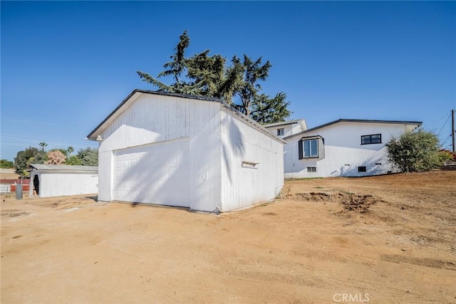 exterior space with an outbuilding and a garage