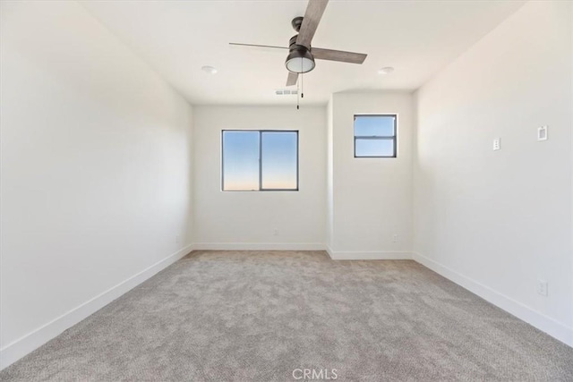 unfurnished room with ceiling fan and light colored carpet