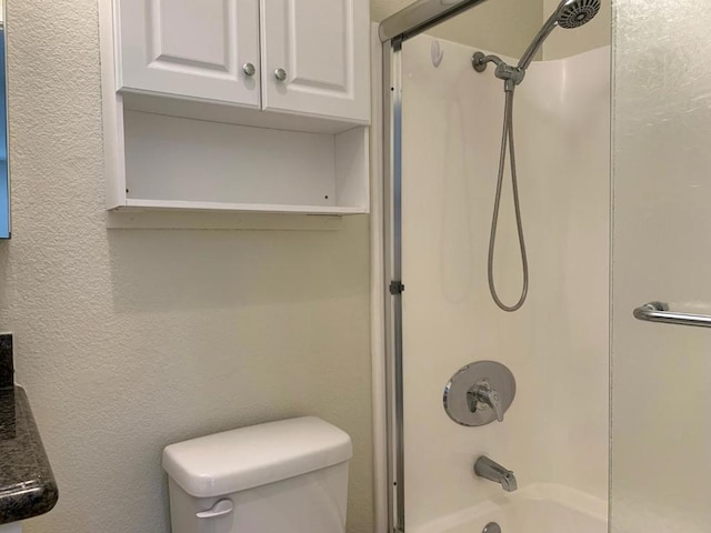 bathroom with shower / bath combination and toilet