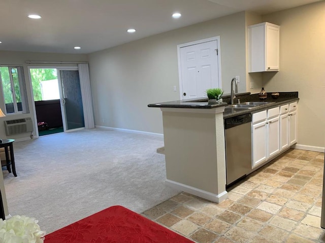 kitchen featuring sink, white cabinetry, stainless steel dishwasher, and light colored carpet